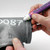 A close image of a Sakura Solid Marker in use on a piping.